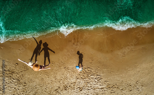 Fototapeta Naklejka Na Ścianę i Meble -  Aerial view of beach with family. Free space for your decoration and summer time. 