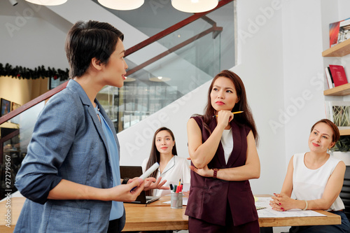 Asian female executive discussing with her colleagues new business plan during a presentation at office © DragonImages