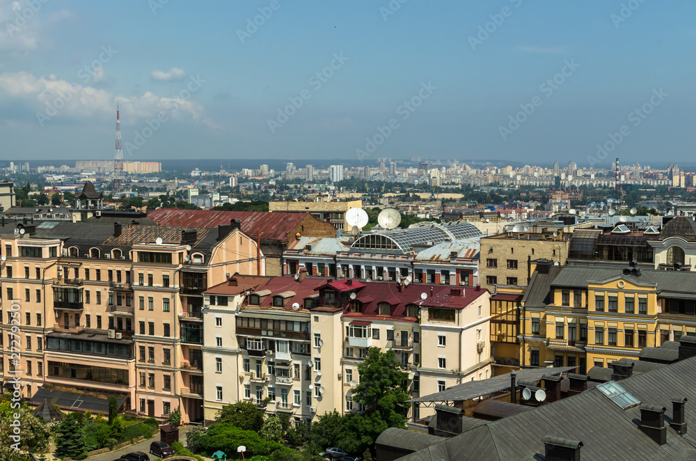 Aerial view from St. Sophia Cathedral on buildings of historical center of Kiev. Beautiful Kiev roofs. In  background - modern buildings of Kiev. Kiev - capital of Ukraine - motherland of Russia