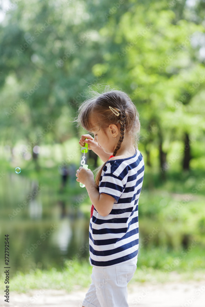 Adorable little girl blowing bubble Adorable little girl blowing bubble