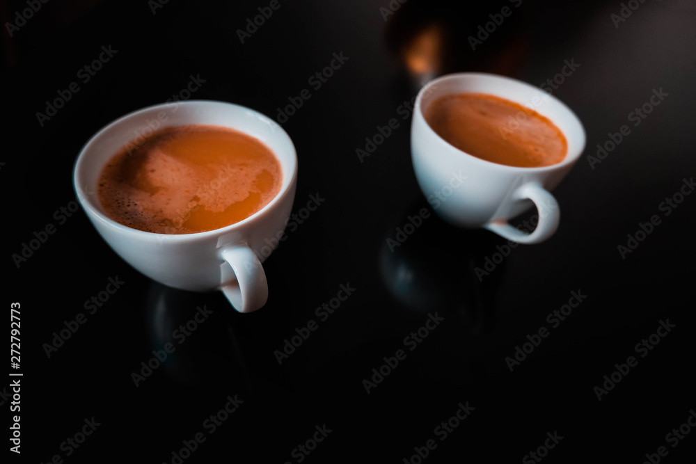 cup of coffee with steam on black background