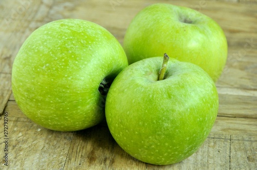 green apples on wooden background