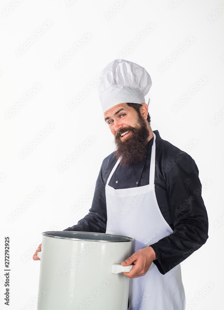 Professional cook holds kitchen utensil. Bearded chef in kitchen holds big  pot. Cook in white apron with pot. Master chef. Cooking, culinary, cuisine.  Food preparation concept. Chef man prepares meal. Stock Photo