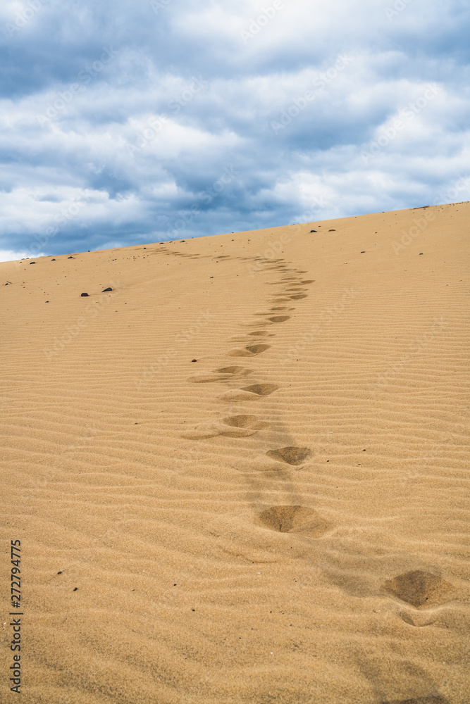 Footprints on the sand dunes. Mystical skies in the background. Footprints on the sand dunes. Mystical skies in the background.