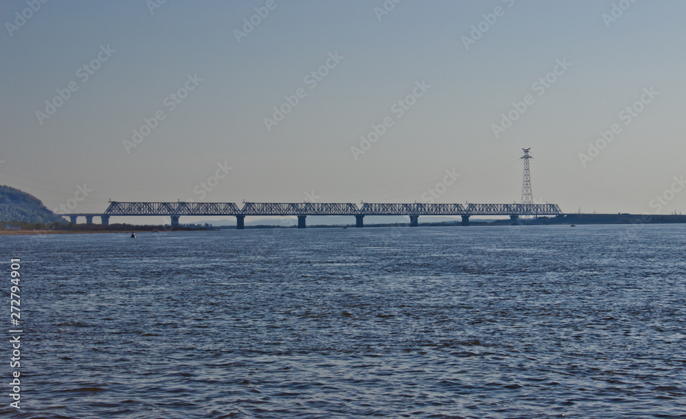 Komsomlsk-on-Amur, Russia, September 21, 2014. Bridge over the river at Amur, view from the shore.