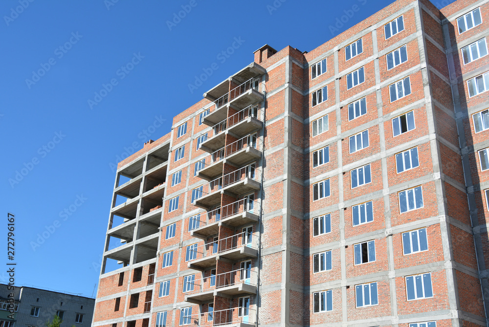 Photo of high-level brick wall building with wall insulation and incomplete balcony.