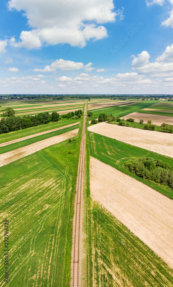 Railroad track amongst rural area aerial view