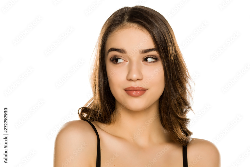 Young woman with makeup, looking aside on white background Young woman with makeup, looking aside on white background