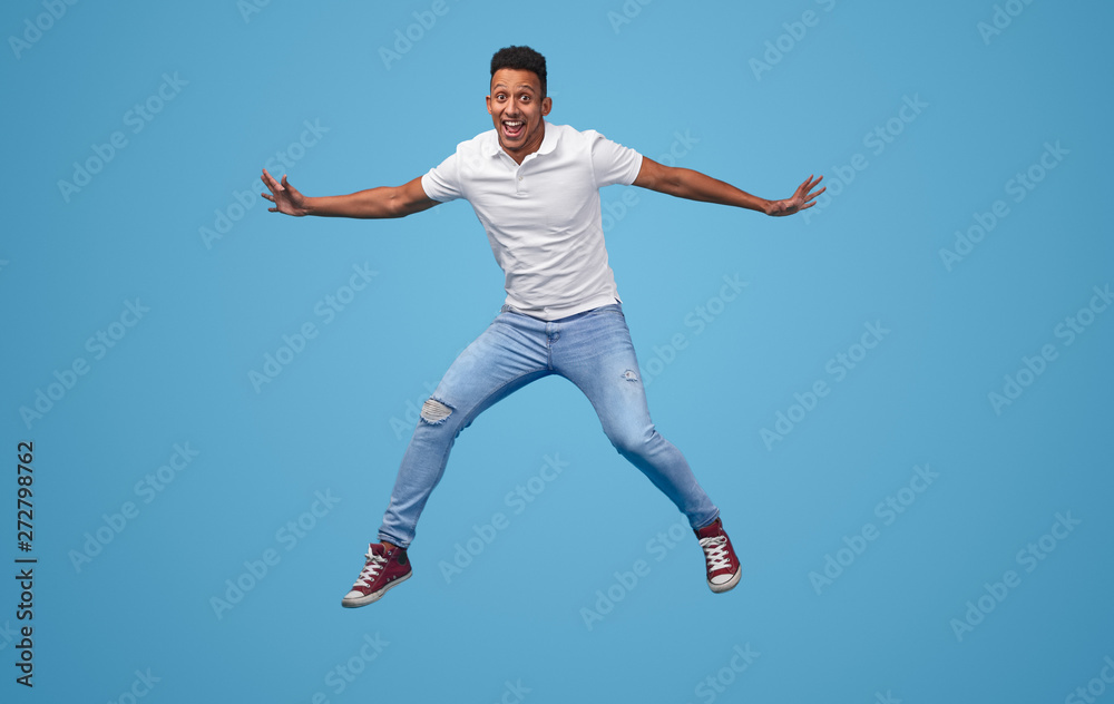 Funny black man jumping and looking at camera