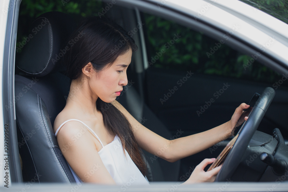 Asian stressed woman near a car breakdown using mobile phone feeling desperate for trouble with vehicle