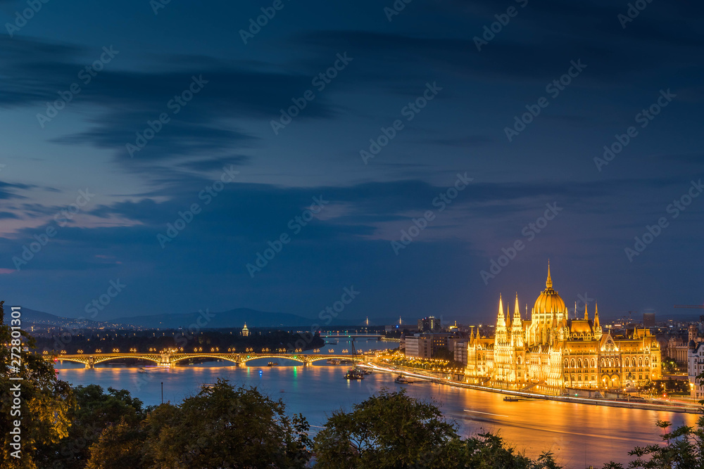 Illuminated aerial urbanscape of Budapestwith the Parliament building and the Margaret Bridge across the Danube River by night.