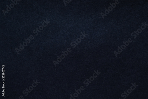Black felt texture abstract art background. Colored fabric fibers surface. Empty space.