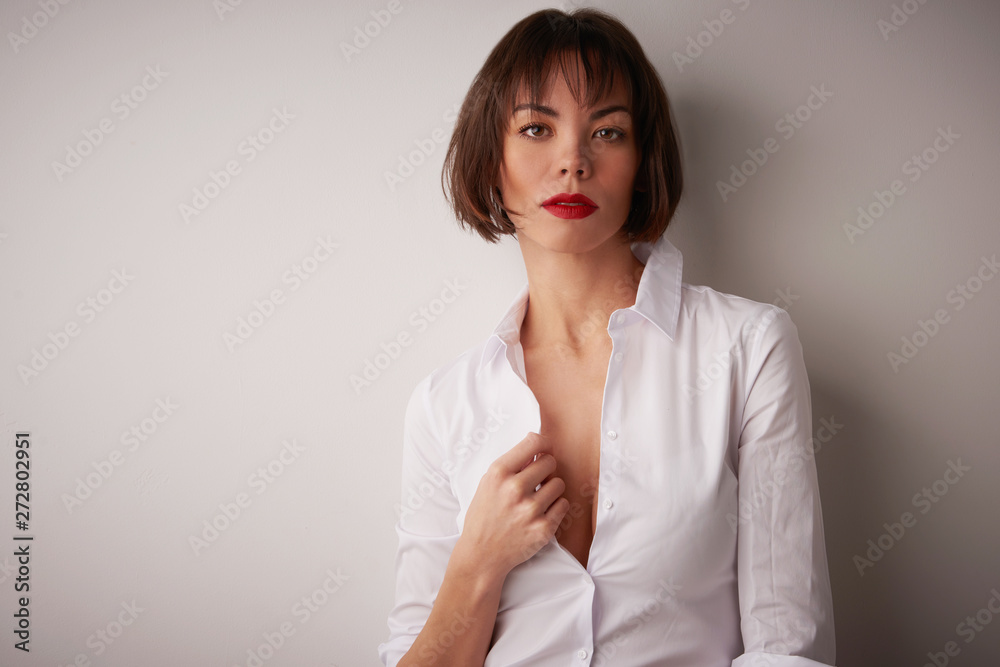Studio portrait of beautiful young woman standing at isolated bacgkround Studio portrait of beautiful young woman standing at isolated bacgkround