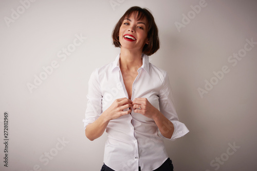 Studio portrait of beautiful young woman standing at isolated bacgkround photo