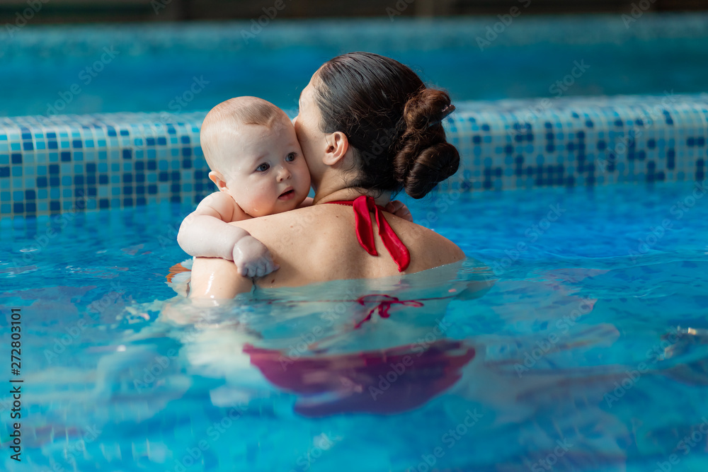 baby with mom learns to swim in the pool baby with mom learns to swim in the pool