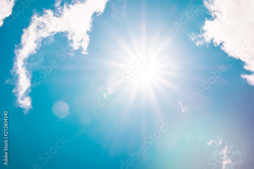 Fototapeta Naklejka Na Ścianę i Meble -  Retro clouds sky with sunbeams and sun flare white fluffy cloudscape nature background retro color style