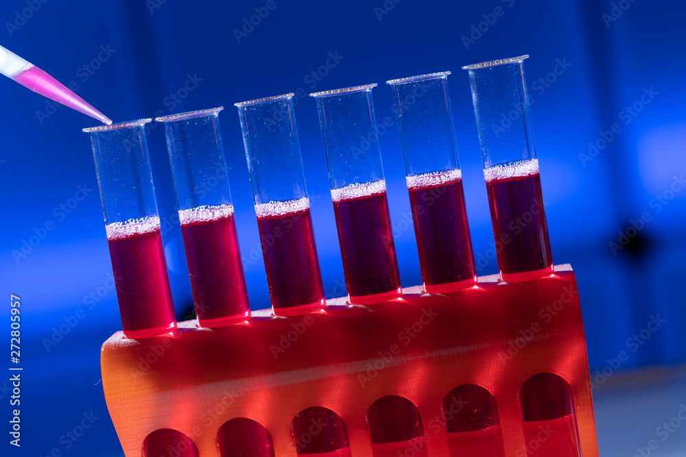 Test tube in rack and pipette media dispenser. Stock Photo Adobe Stock