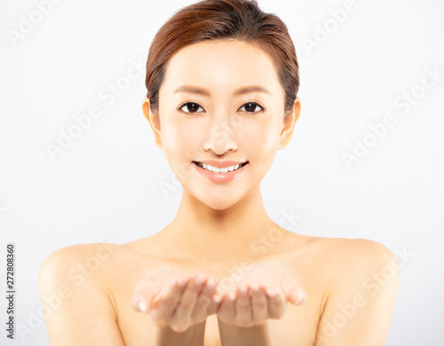 beauty Asian woman showing product on open hand