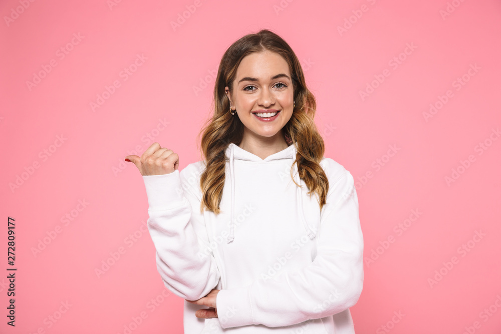 Smiling blonde woman wearing in casual clothes pointing away Smiling blonde woman wearing in casual clothes pointing away
