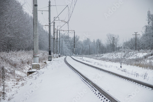 Winter Russian Railway. Public transport. winter road. Rails and sleepers. Electricity