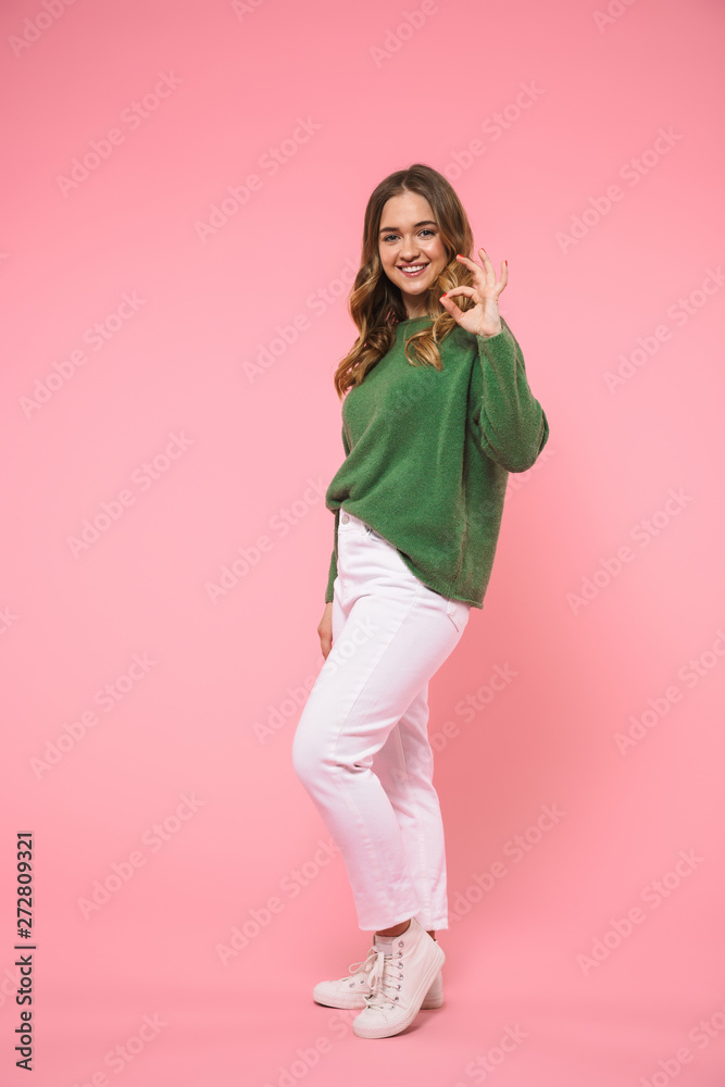 Full length image of Smiling woman wearing in green sweater Full length image of Smiling woman wearing in green sweater