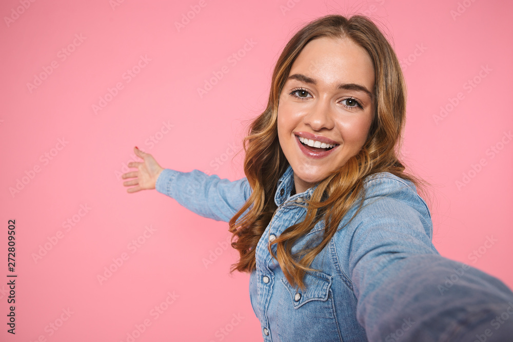 Cheerful blonde woman wearing in denim shirt making selfie Cheerful blonde woman wearing in denim shirt making selfie