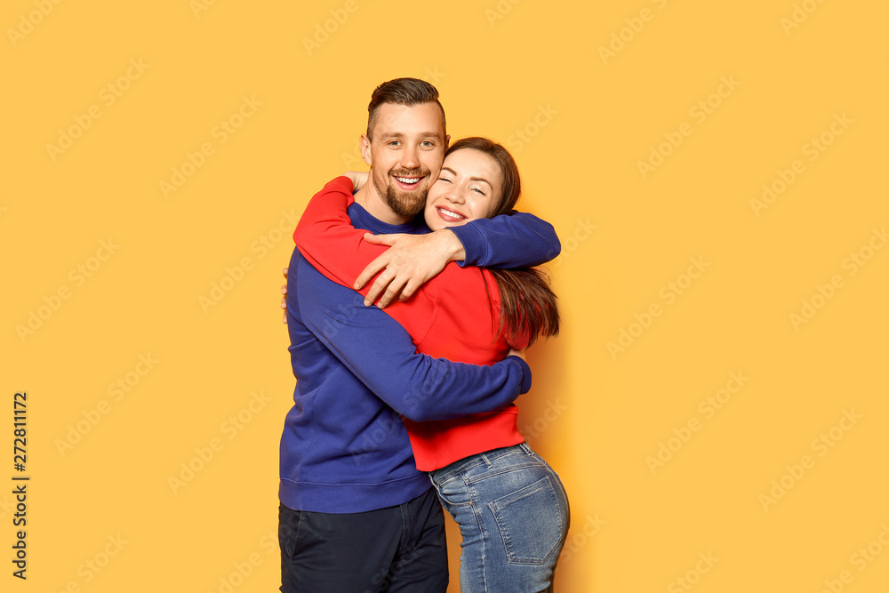 Obraz premium Happy young couple on color background