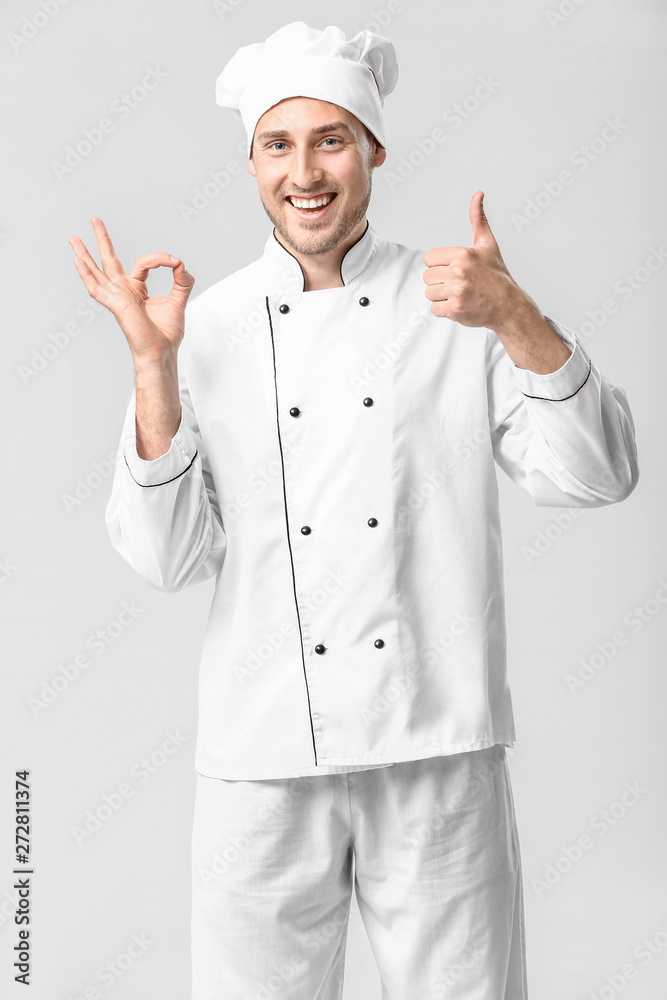 Handsome male chef showing thumb-up on white background Handsome male chef showing thumb-up on white background