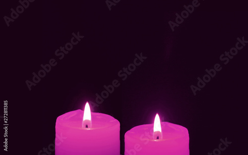 Shining a Pair of Vivid Pink Candles on Black Background with Copy Space