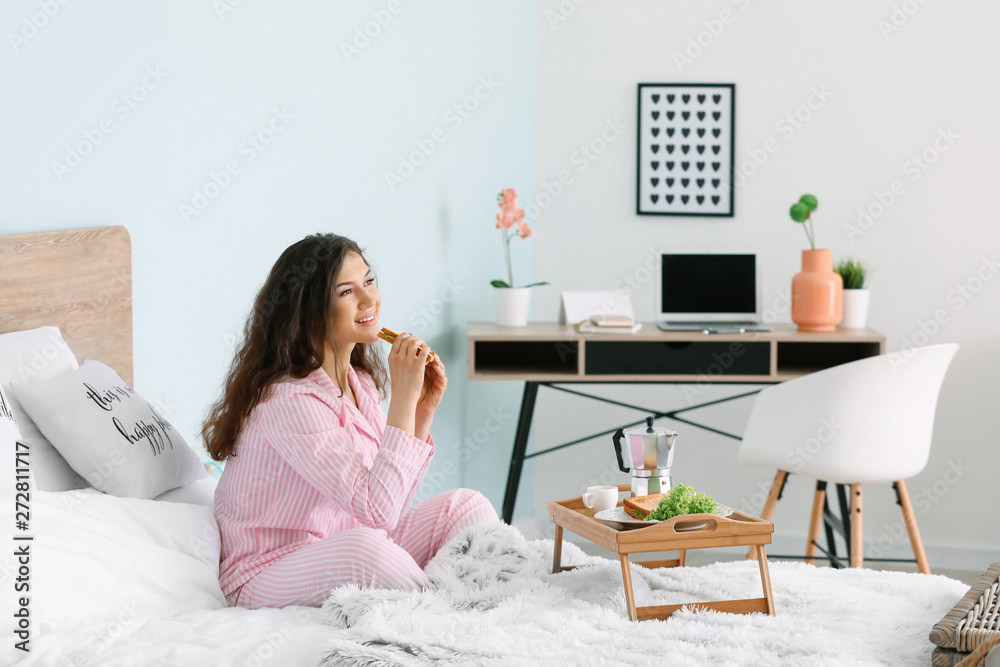 Beautiful young woman having breakfast in bed Beautiful young woman having breakfast in bed
