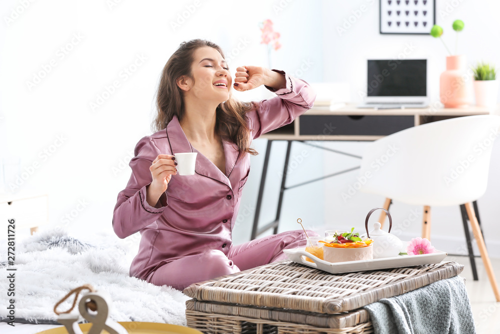 Beautiful young woman having breakfast in bed Beautiful young woman having breakfast in bed