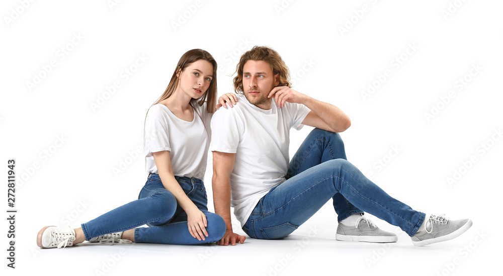 Stylish young couple in jeans on white background Stylish young couple in jeans on white background