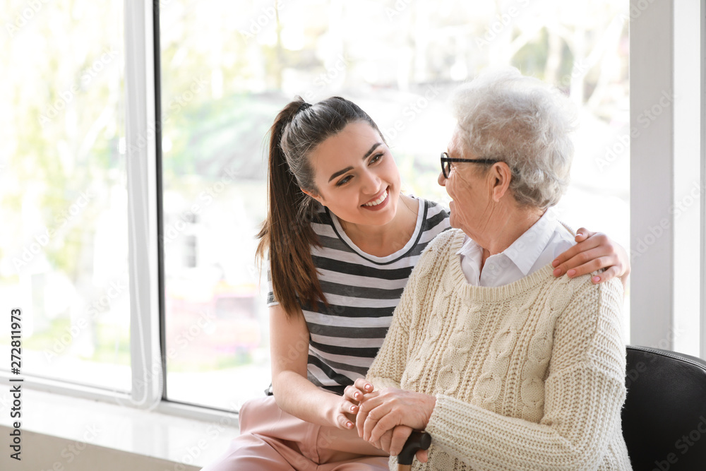 Caregiver with senior woman in nursing home