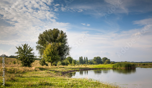 River nature landscape, summer sunny day and cloudy sky background.