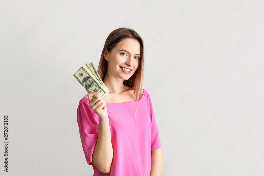 Happy young woman with money on white background Happy young woman with money on white background