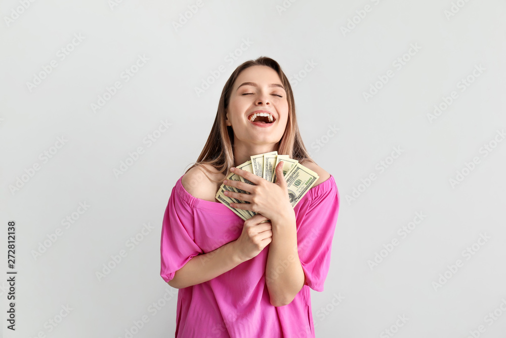 Happy young woman with money on white background