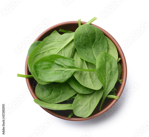 фотографія Bowl with fresh spinach on white background