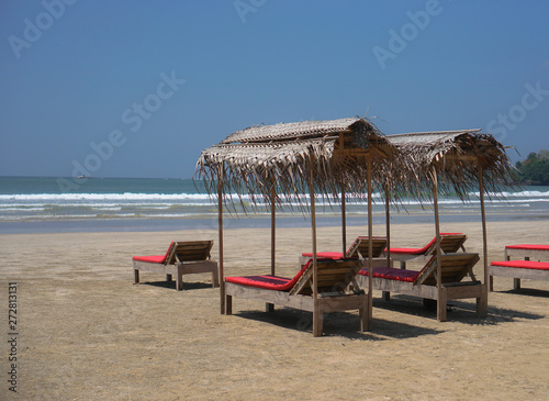 Beautiful Sri Lankan view of the Indian Ocean with sun loungers on the beach. Summer holidays in Asia. Stock photos