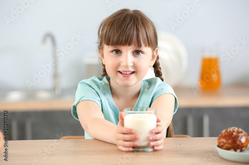 Cute little girl with glass...