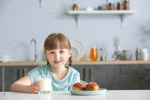 Cute little girl with glass...