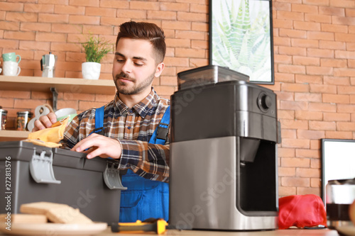 Man repairing coffee machin...