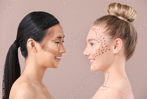 Young women with contouring makeup on color background