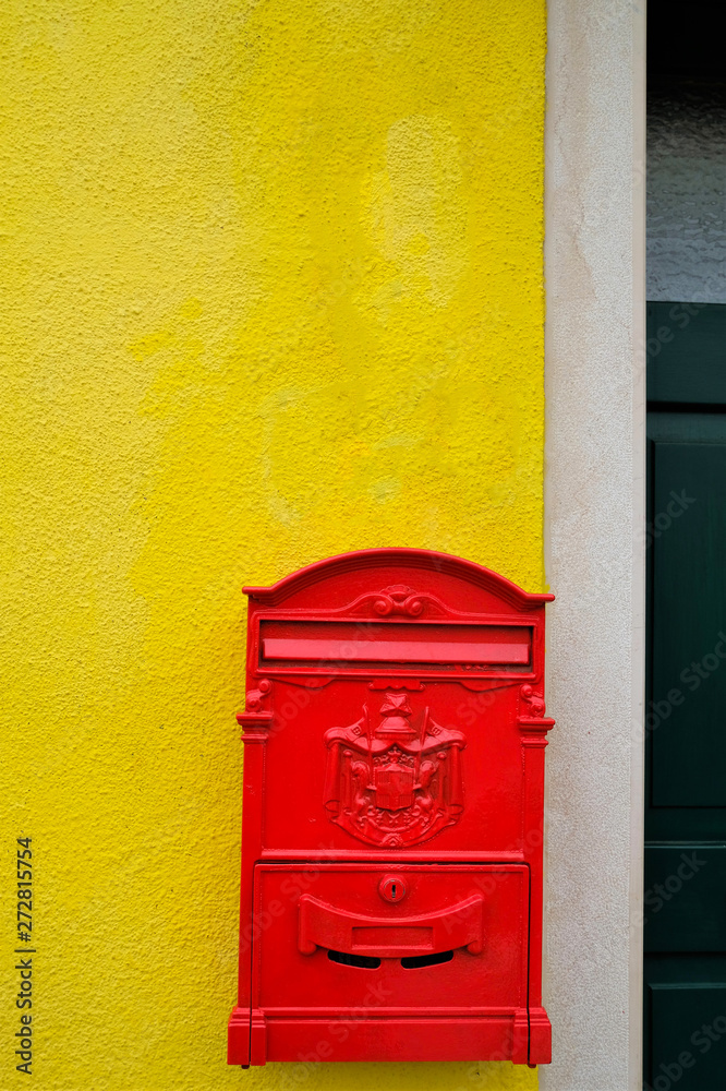 red letter box hanging on a yellow wall red letter box hanging on a yellow wall