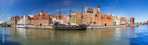 Panorama of the old town in Gdansk with historical port crane reflected in Motlawa river, Poland photo