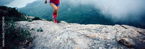 Canvas Print Healthy lifestyle woman ultramarathon runner running up to the seaside mountain