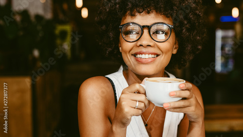 Woman at cafe having coffee photo