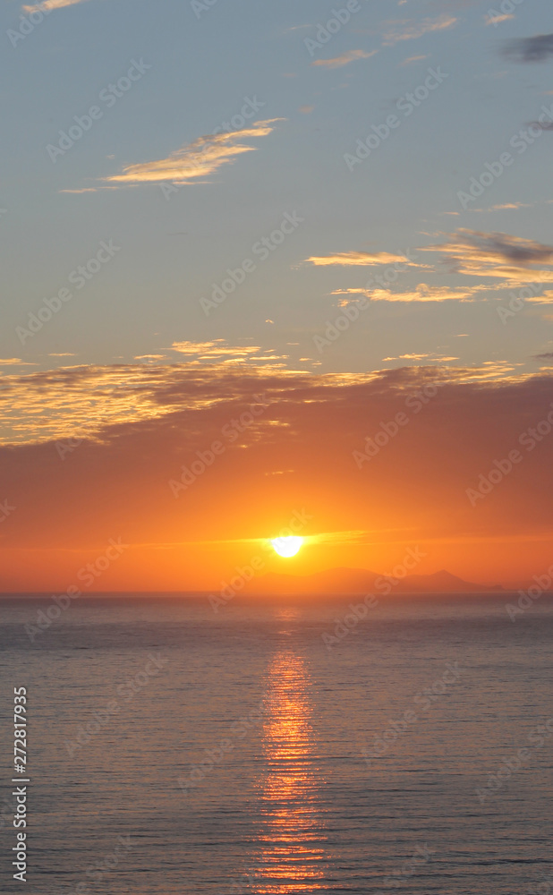 Obraz premium Beautiful summer sunset or sunrise by the sea. Red and orange spectacular cloudy sunset vertical background.