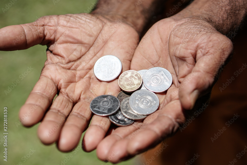 Coins in dark working hands. Beyond the poverty line in Asian countries. Subject soap bar. Coins in dark working hands. Beyond the poverty line in Asian countries. Subject soap bar.