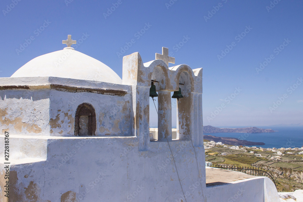Santorini old white dome church and bright clear sky and sea. Cycladic landscape.