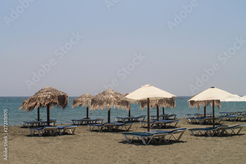 Sandy beach with sun beds and umbrellas